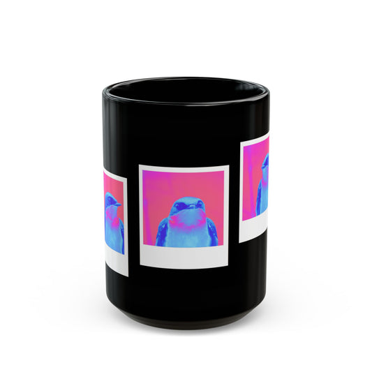 Black mug with 3 polaroids of a blue bird in front of a pink background.