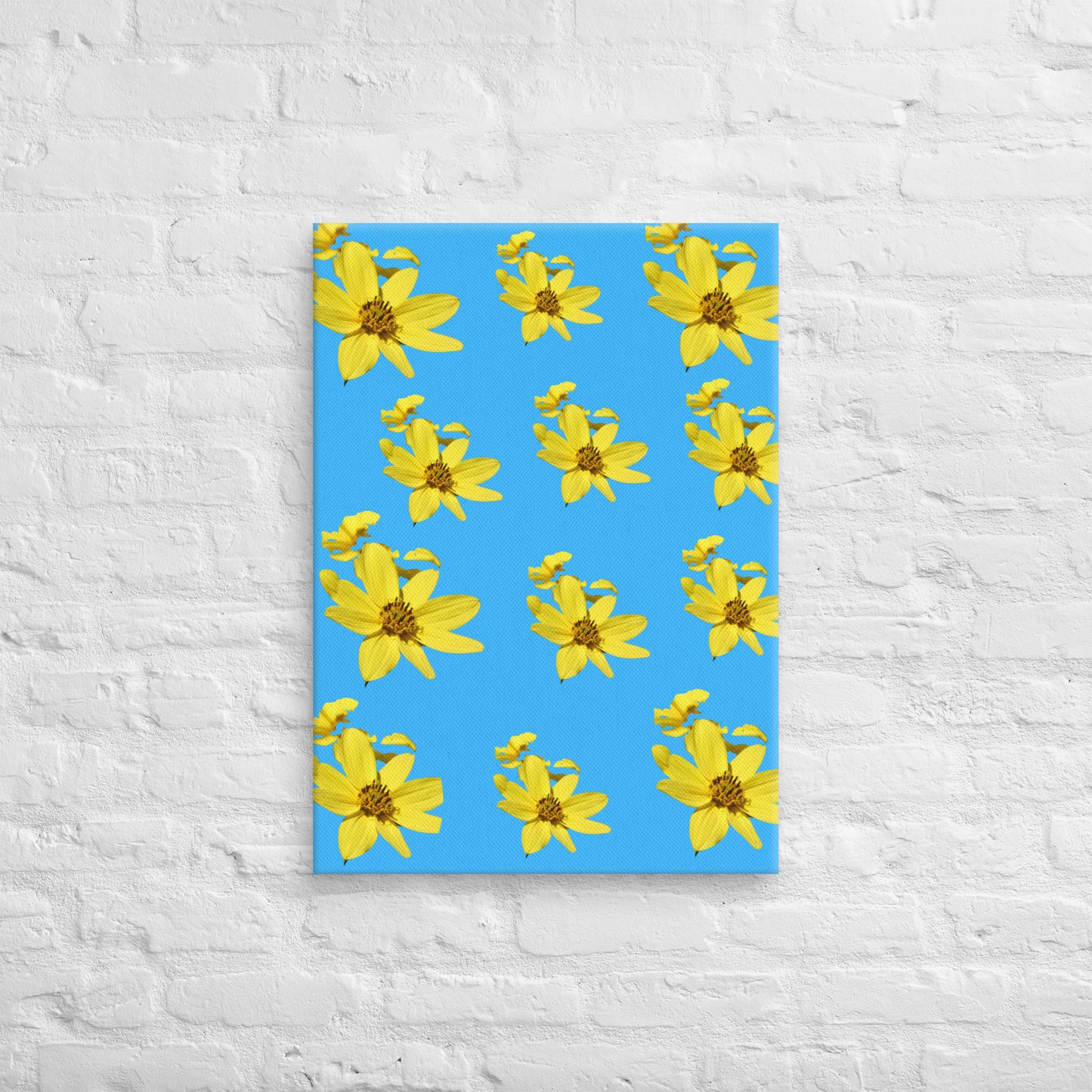 Canvas with yellow flower pattern on a blue cover against a white brick wall background