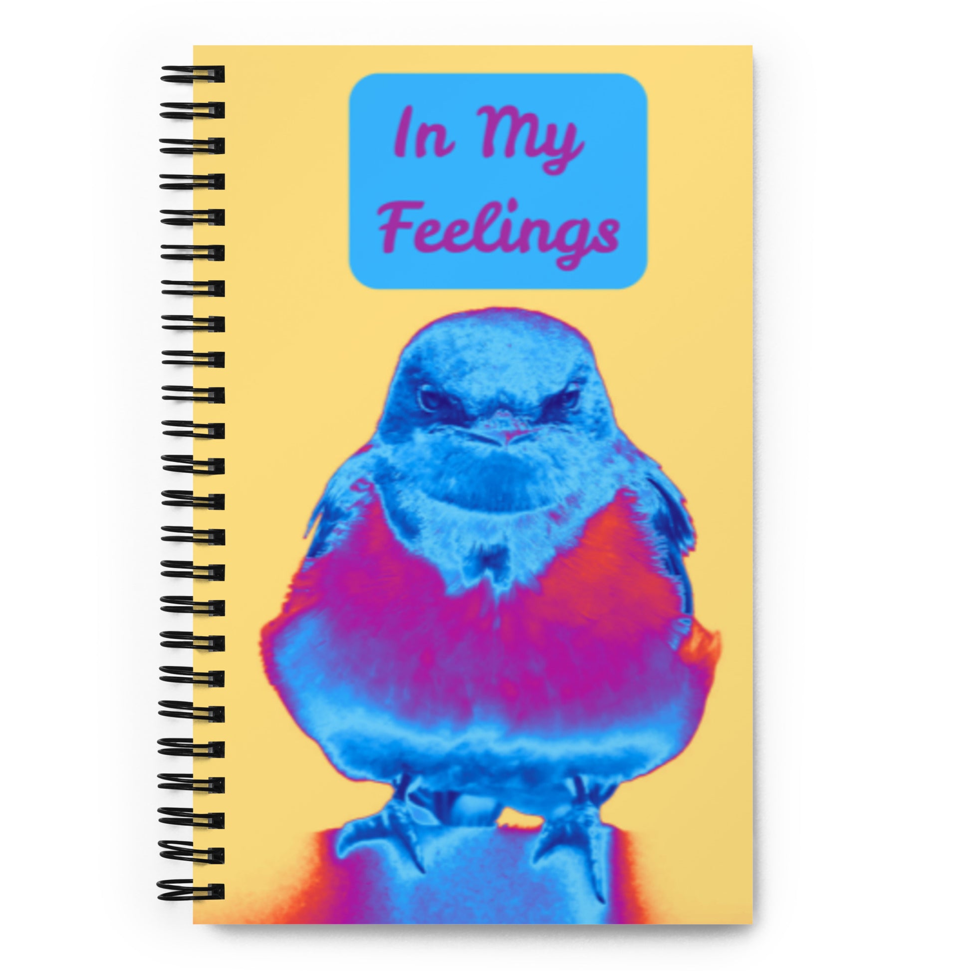 Notebook with a colorful bird illustration and 'In My Feelings' text on a yellow background