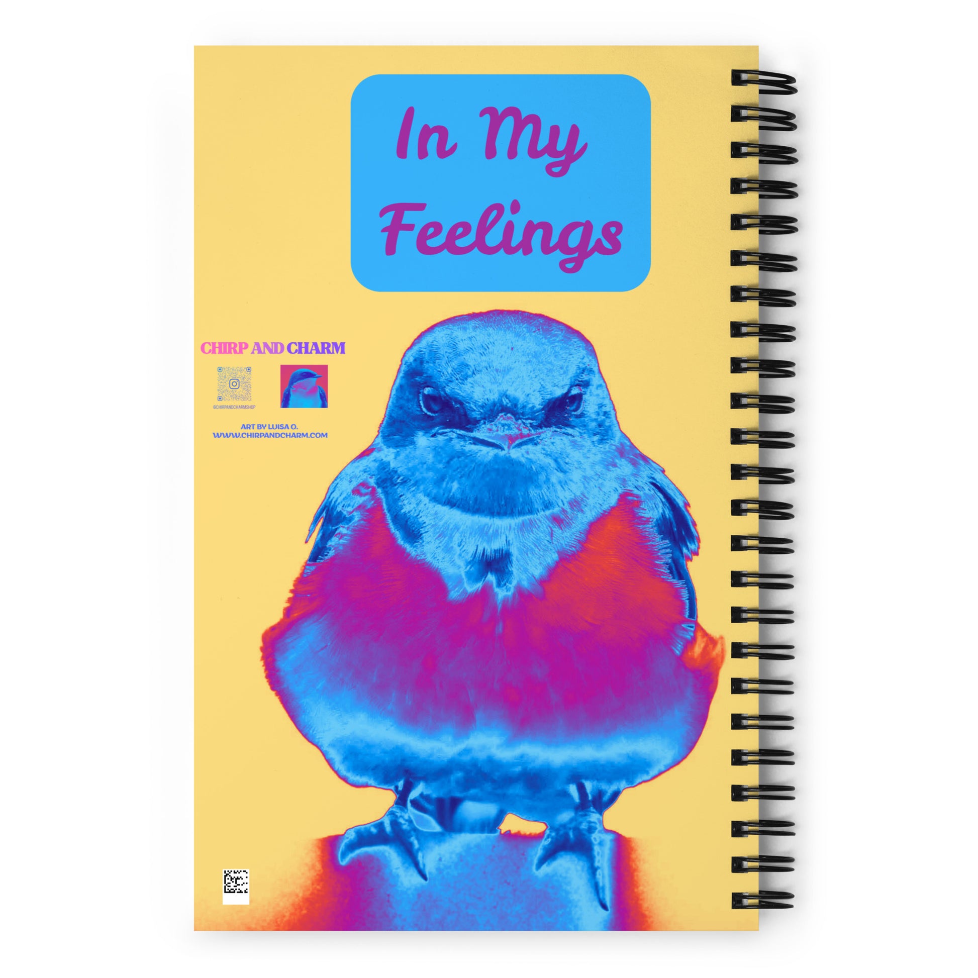 Notebook with a colorful bird illustration and 'In My Feelings' text on a yellow background