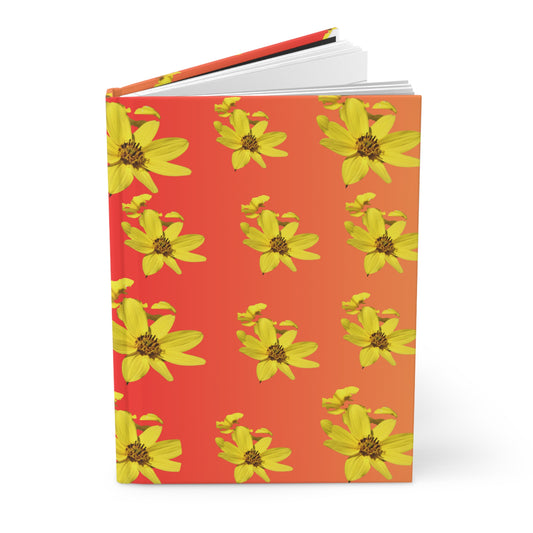 Notebook with yellow flower pattern on an orange ombré background.