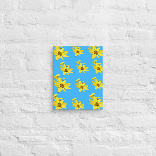 Canvas with yellow flower pattern on a blue cover against a textured white wall background