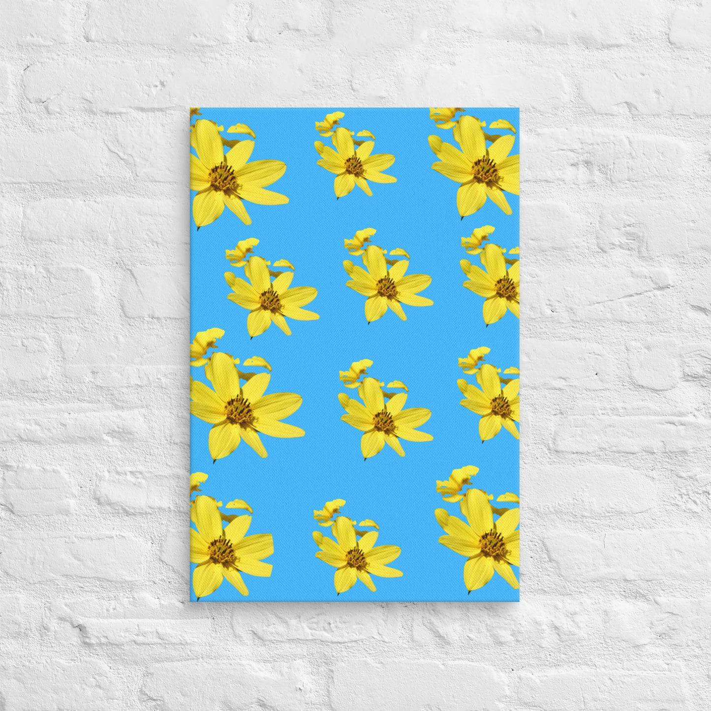 Canvas with yellow floral pattern on a blue background, placed on a textured white surface.