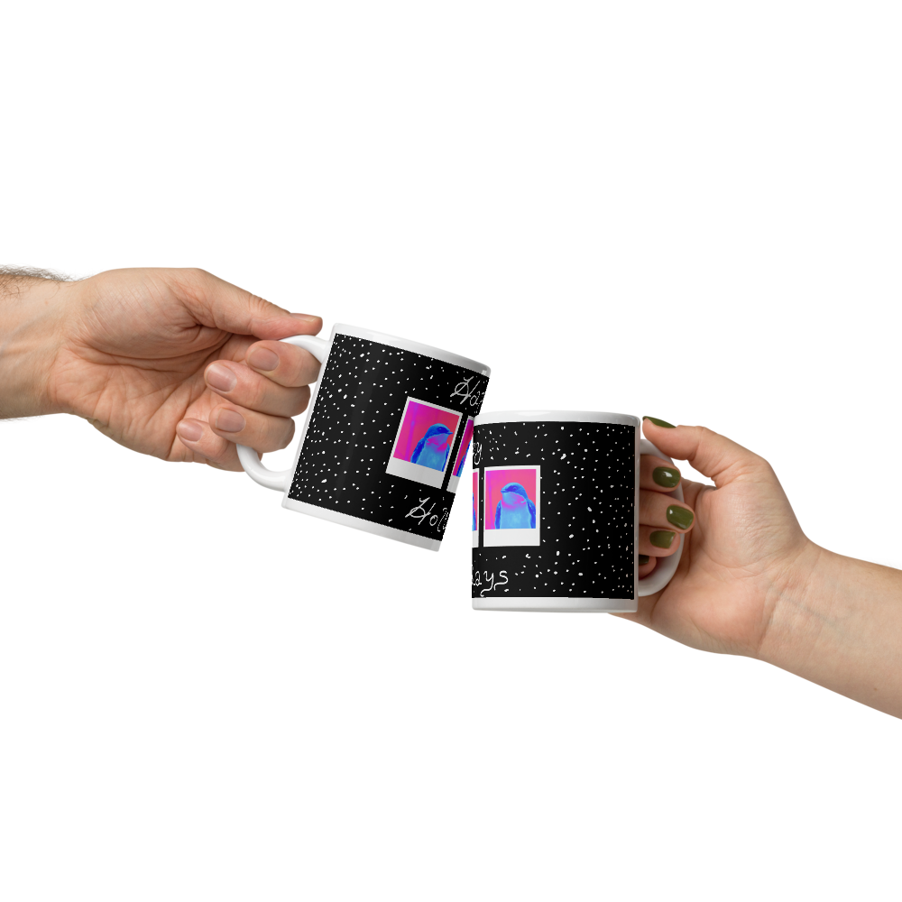 Two hands toasting with mugs that have a festive winter happy holidays design. 