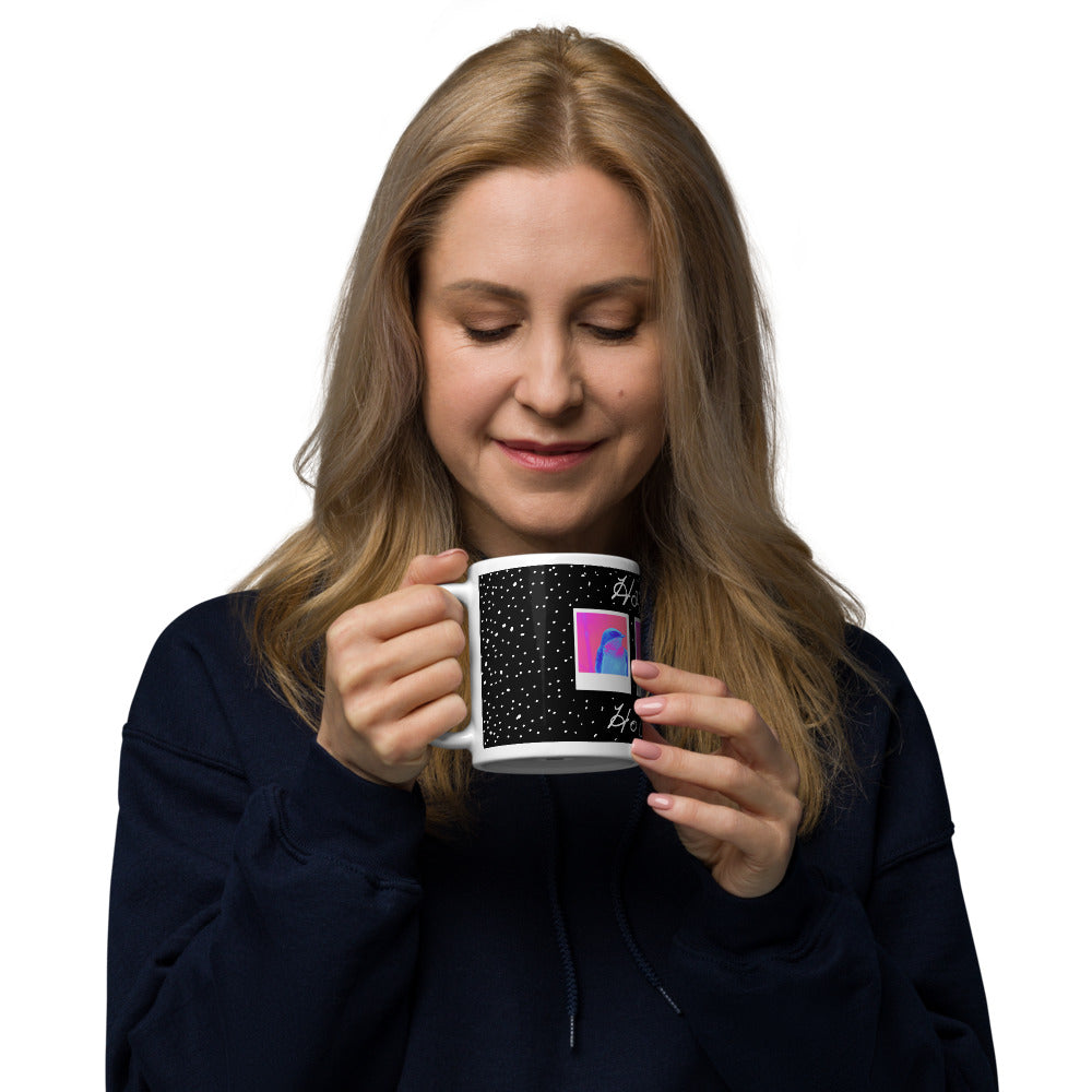 Woman holding a mug with a colorful design on a white background